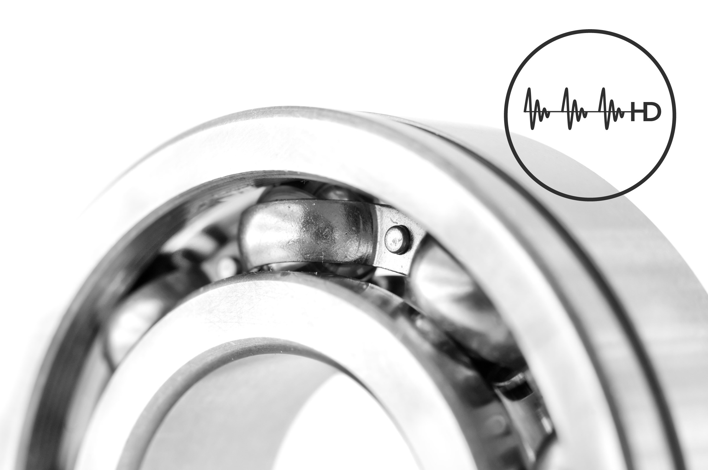 Close-up of ball bearings in gray and white with a small circular HD symbol to the right