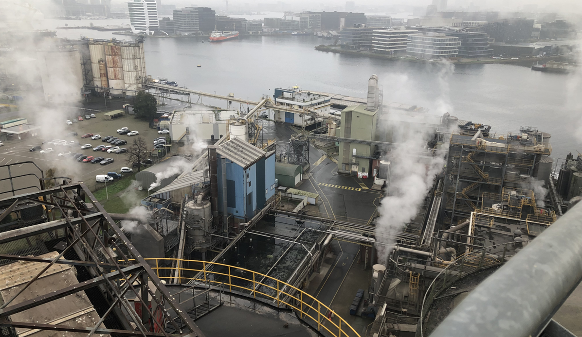 Aerial view of a factory alongside a port